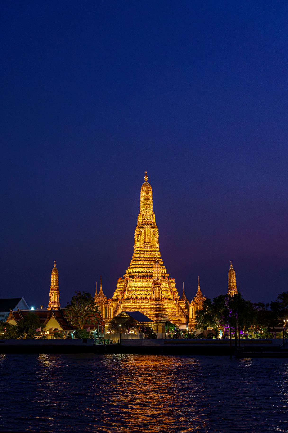 Wat Arun temple illuminated at night in Bangkok, Thailand